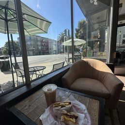 Delicious and classic breakfast bagel sandwich & iced oat milk latte