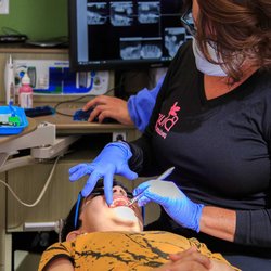 Blume Pediatric Dentistry - Dr. Carlen Blume performing an examination at Blume Pediatric Dentistry
