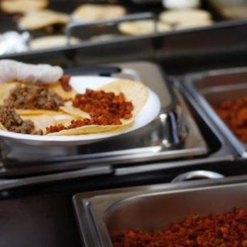 Tacos El Diablito - a person holding a plate of food - Caterers Near Me Tacos El Diablito - a person holding a plate of food - Caterers Near Me