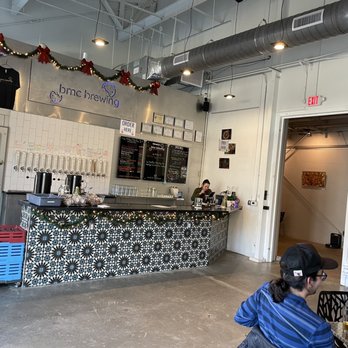 bmc brewing - a man sitting at a counter - Breweries Near Me - Pittsboro, North Carolina