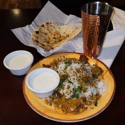 India Grill - Chicken biryani with raita, garlic naan, and kheer rice pudding for dessert.