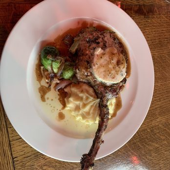 Maximilien - Cote de Proc 16oz pork tomahawk, garlic butter, demi-glacé, mash potatoes & brussle sprouts with caramelized onions and thick cut bacon ends - French Near Me - Seattle, Washington Maximilien - Cote de Proc 16oz pork tomahawk, garlic butter, demi-glacé, mash potatoes & brussle sprouts with caramelized onions and thick cut bacon ends - French Near Me - Seattle, Washington