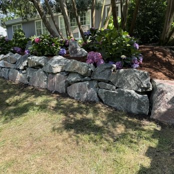 Renovatio Landscape & Design - Gun Metal boulder wall - Tree Services Near Me Renovatio Landscape & Design - Gun Metal boulder wall - Tree Services Near Me
