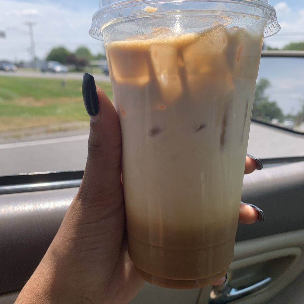 Java Hut - a hand holding a cup of iced coffee - Coffee & Tea Near Me - Decherd, Tennessee Java Hut - a hand holding a cup of iced coffee - Coffee & Tea Near Me - Decherd, Tennessee