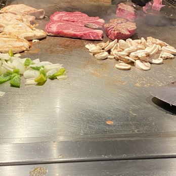 Miyabi - a chef preparing food on a grill - Japanese Near Me - Savannah, Georgia Miyabi - a chef preparing food on a grill - Japanese Near Me - Savannah, Georgia