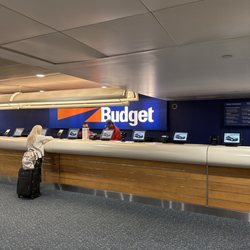 Budget Rent A Car - One persons working the entire counter. 14 spots total and one guy working.