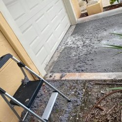 Romano's Appliance Repair - Pile of lint and debris cleaned out from a dryer vent on the ground outside a home, showcasing maintenance work