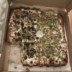 Sicilian pizza with sausage, green peppers and black olives