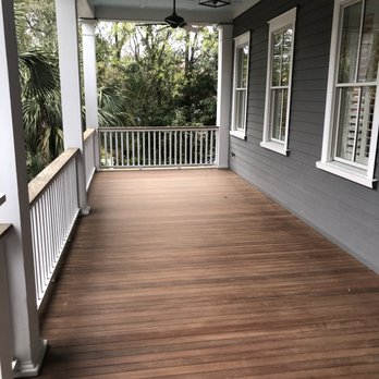 Signature Hardwood - a porch with white railings and wood flooring - Flooring Near Me Signature Hardwood - a porch with white railings and wood flooring - Flooring Near Me