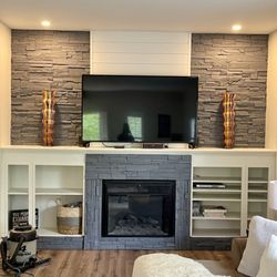 Forever Kitchens & Baths - Living room remodel of flooring and fireplace wall!