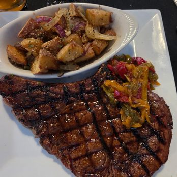 Bone-Appetite - Bone-in ribeye and potatoes with peppers and opinions for the steak topping. - Steakhouses Near Me - Lexington, South Carolina Bone-Appetite - Bone-in ribeye and potatoes with peppers and opinions for the steak topping. - Steakhouses Near Me - Lexington, South Carolina