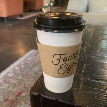 1418 Coffee House - To-go cup with a view of cozy couches in the background. - Coffee & Tea Near Me - Plano, Texas