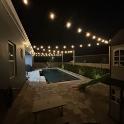 All Seasons Sprinkler and Landscape Lighting - Backyard string lights. Also installed 3 wooden polls to support them over the pool.
