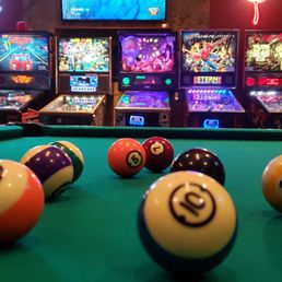 a pool table with eight billiards a pool table with eight billiards