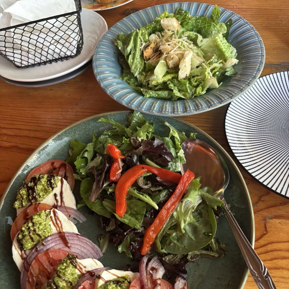 Cesar's salad up top and caprese salad on bottom. Cesar's salad up top and caprese salad on bottom.