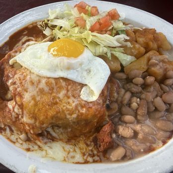 El Patio De Albuquerque - Carne Adovada inside sopapilla with red chile topped with egg - New Mexican Cuisine Near Me - Albuquerque, New Mexico