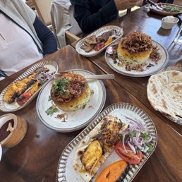Seabass (lower). Chicken Barg (top left). Barg (top right).  Sabzi Polo (center left). Adas Polo (center right).