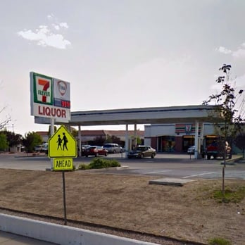 7 eleven - a school crossing sign in front of a gas station - Gas Stations Near Me - Albuquerque, New Mexico