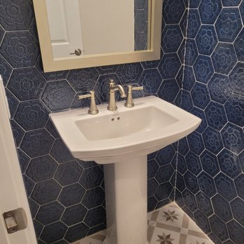 Luna Tile - a bathroom with a pedestal sink and mirror - Flooring Near Me Luna Tile - a bathroom with a pedestal sink and mirror - Flooring Near Me
