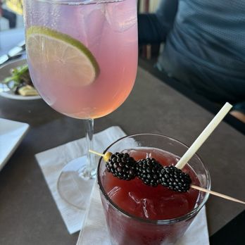 Peaks Restaurant - Strong cocktails | Empress 1908 & Tonic (L) & House Crafted Hot Honey Blackberry (R) - New American Near Me - Palm Springs, California Peaks Restaurant - Strong cocktails | Empress 1908 & Tonic (L) & House Crafted Hot Honey Blackberry (R) - New American Near Me - Palm Springs, California