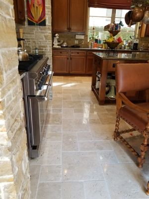 Chiseled Edge Kitchen Floor Restoration - This chiseled edge travertine floor was looking dull and worn and needed our expertise in resin diamond polishing! Once done, their “eat off the floor” chiseled edge travertine kitchen tile is ready to be served! Brought to you by Bizfloors!!