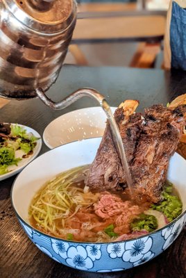 Photo of 1618 Asian Fusion - Austin, TX, US. Pho Rib - Vietnamese beef broth with Filet Mignon, Grilled Ribs & a Vital Farm Egg.