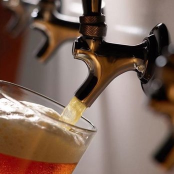 Uncle Sam's - a beer being poured into a glass - Pizza Near Me - Phoenix, Arizona Uncle Sam's - a beer being poured into a glass - Pizza Near Me - Phoenix, Arizona
