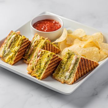 Eggholic - a sandwich and chips on a plate - Indian Near Me - Suwanee, Georgia Eggholic - a sandwich and chips on a plate - Indian Near Me - Suwanee, Georgia