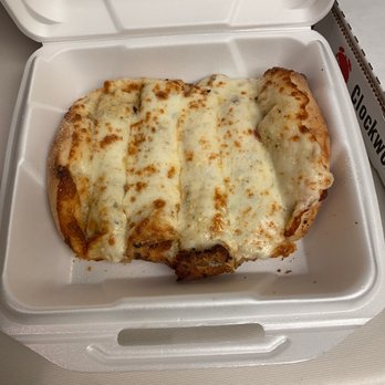 Clockwork Pizza - Cheese Bread - A slice of pizza with melted cheese in a foam takeout box, placed on a white surface. - Pizza Near Me - Tempe, Arizona
