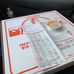Mamma Mia Takeout - This photo shows a pizza box with a dipping sauce, and guess what ? The pizza's inside