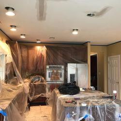 Edwin Painting Company - Kitchen fully covered with plastic and drop cloths on the floor to protect the surroundings from sanding and plastering the ceiling.