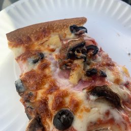 a slice of pizza on a paper plate a slice of pizza on a paper plate