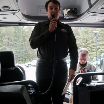 Mountaineer Lodge - Welcoming hotel manager George gives our group an orientation on the bus. - Hotels Near Me - Lake Louise, Alberta