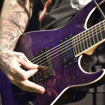 Warrior Zone - a closeup of a person playing a guitar - Arcades Near Me - Fort Campbell, Kentucky