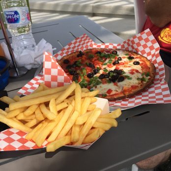 Spa Beach Bistro - cauliflower pizza with cheese on half of it and vegetables plus an order of fries. YUM! - Pizza Near Me - St. Petersburg, Florida
