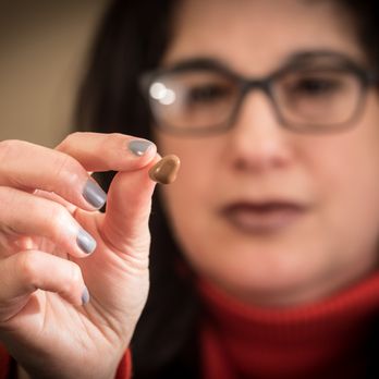 Wilks Hearing Center - Barbara looking at one of our tiny aids - Hearing Aid Providers Near Me - Lawrence, New York Wilks Hearing Center - Barbara looking at one of our tiny aids - Hearing Aid Providers Near Me - Lawrence, New York