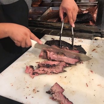 Ten50 BBQ - Pit Master carving hickory smoked beef brisket - Barbeque Near Me - Richardson, Texas