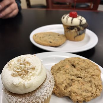 Butterfingers - Banana cupcake and butterscotch cookie with marble cupcake and peanut butter chunk cookie in background - Specialty Food Near Me - Munster, Indiana Butterfingers - Banana cupcake and butterscotch cookie with marble cupcake and peanut butter chunk cookie in background - Specialty Food Near Me - Munster, Indiana