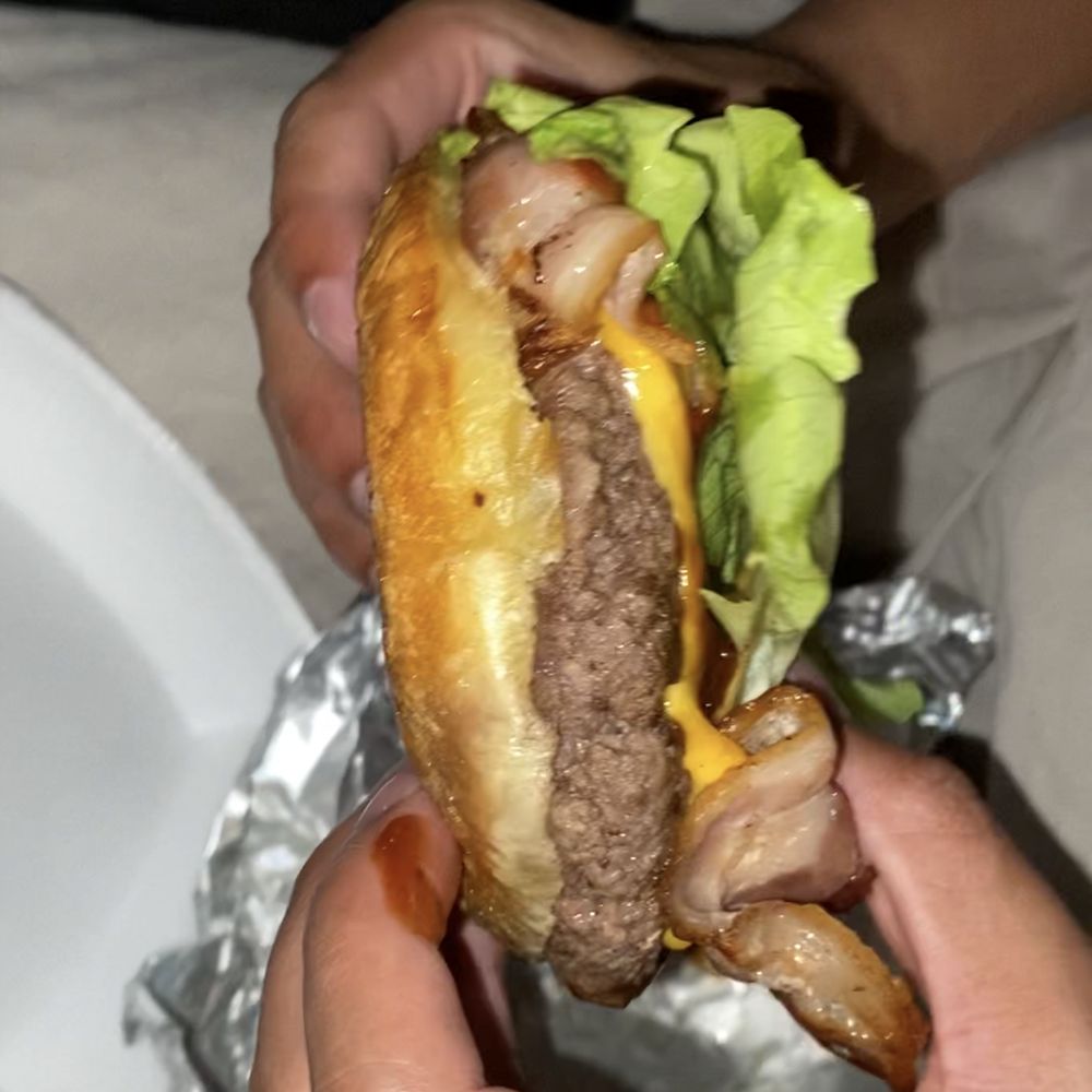 Doghouse - a person holding a hamburger in their hands - Hot Dogs Near Me - Miami, Florida Doghouse - a person holding a hamburger in their hands - Hot Dogs Near Me - Miami, Florida