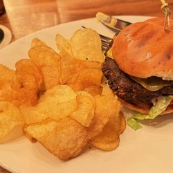 Foxhole Culinary Tavern - Black bean patty burger with side of kettle chips.