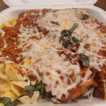 The Garlic Pit Pasta House - Yummy Pit Plate with Cheesy Shells chicken cutlets garlic roasted potatoes and meat sauce with Mozzarella cheese and fresh basil - Italian Near Me - Webster, New York The Garlic Pit Pasta House - Yummy Pit Plate with Cheesy Shells chicken cutlets garlic roasted potatoes and meat sauce with Mozzarella cheese and fresh basil - Italian Near Me - Webster, New York