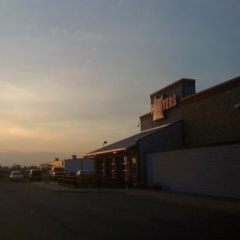 Hooters - the sun setting over a parking lot - Sports Bars Near Me - Saginaw, Michigan