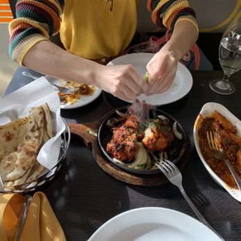 Amber India - Milpitas - garlic naan, tandoori chicken, and the remnants of the idli stir fry - Indian Near Me - Milpitas, California