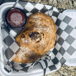 Custom calzone. Italian sausage, Canadian bacon, onion, black olives. Custom calzone. Italian sausage, Canadian bacon, onion, black olives.
