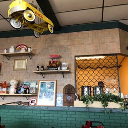 a yellow car suspended from the ceiling
