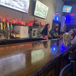 a man and woman sitting at a bar