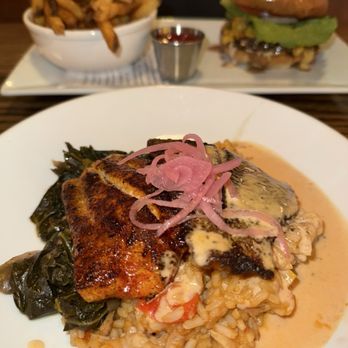 Copper Crown - BLACKENED NC CATFISH andouille jambalaya, collard greens, honey- tabasco butter // burger in the back - New American Near Me - Asheville, North Carolina