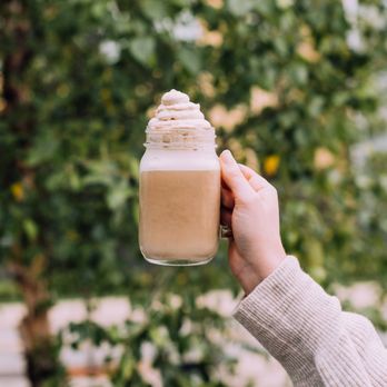 Caribou Coffee - a person holding a jar of coffee - Coffee & Tea Near Me - Bloomington, Minnesota