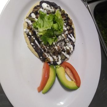 Blue Tequila - a taco and avocado on a white plate - Bars Near Me - Queens, New York Blue Tequila - a taco and avocado on a white plate - Bars Near Me - Queens, New York