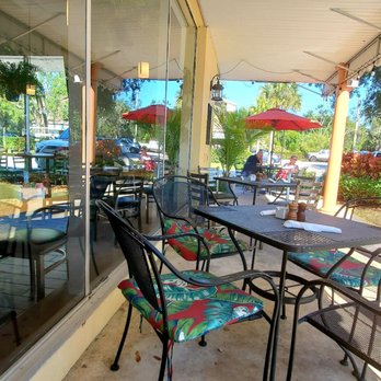 Michael’s On 7th - a patio with tables and chairs - American Near Me - Vero Beach, Florida